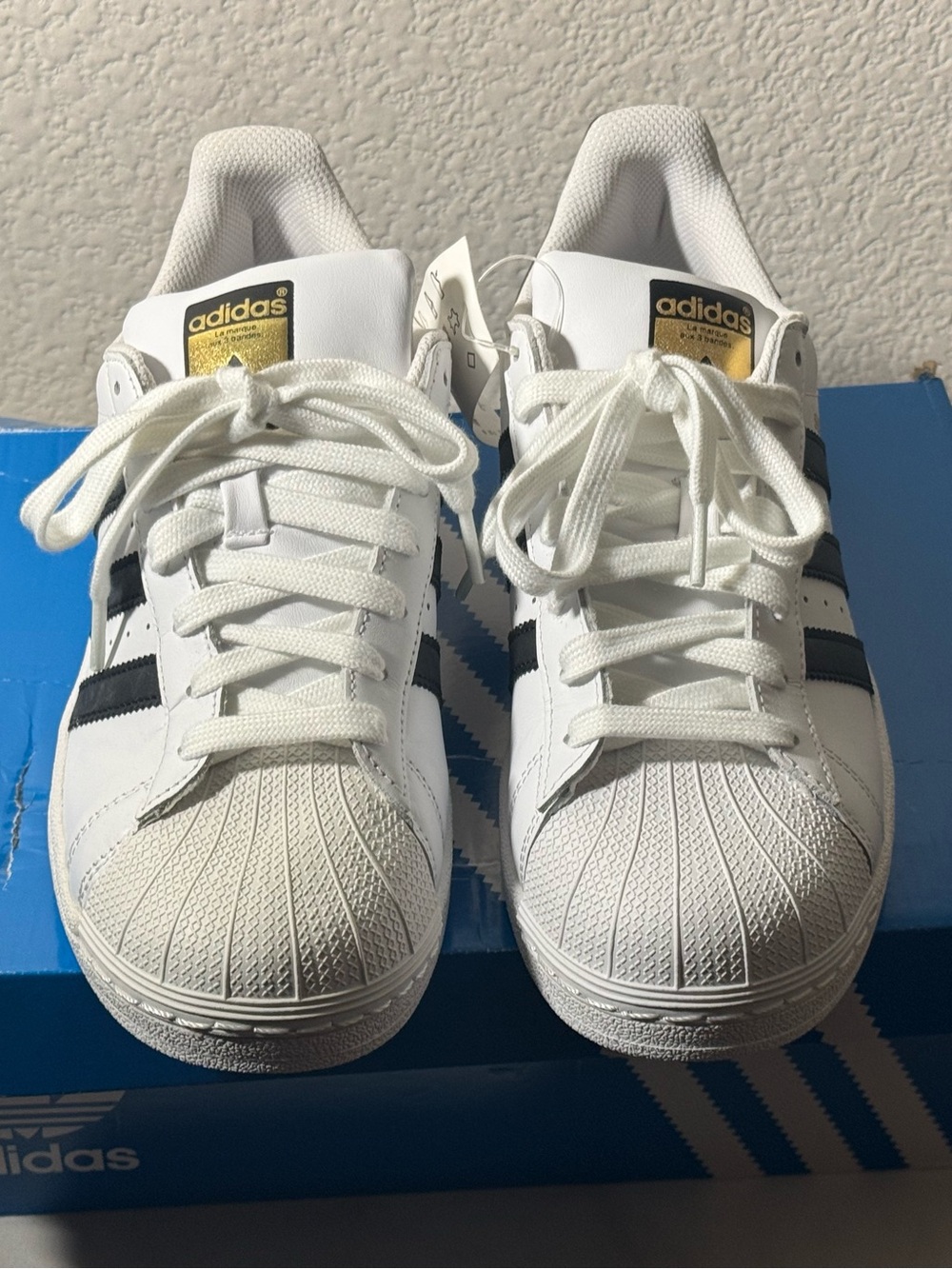 Adidas Superstar Sneakers with Black Stripes and Gold Tongue Logo